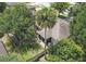 Aerial shot of the backyard with mature trees, a screened-in porch and perimeter fence at 416 Country View Cir, Deland, FL 32720
