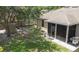 Backyard of home features a screened in patio, mature landscaping, a shed, and green lawn at 416 Country View Cir, Deland, FL 32720