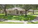 Angle view of a one-story home with neat landscaping, mature trees and sidewalks at 416 Country View Cir, Deland, FL 32720