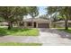 Charming single-story home featuring a well-manicured front lawn, two-car garage and inviting front door at 416 Country View Cir, Deland, FL 32720