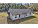 Back of house featuring a covered patio area and a lush green lawn at 7 Hill Prince Dr, Ocala, FL 34482