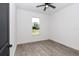Cozy bedroom features neutral walls, tile flooring, ceiling fan, and view of the outdoors through the window at 7 Hill Prince Dr, Ocala, FL 34482