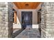 Front door is accented by stone pillars and wood at 7 Hill Prince Dr, Ocala, FL 34482