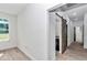 Hallway showcasing tile floors and a barn door that leads to a bathroom in a well-lit setting at 7 Hill Prince Dr, Ocala, FL 34482