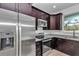 Close up on the kitchen with stainless steel appliances, granite countertops and dark wood cabinets at 7 Hill Prince Dr, Ocala, FL 34482