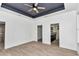 Spacious main bedroom features wood-look tile flooring and access to ensuite bath and closet at 7 Hill Prince Dr, Ocala, FL 34482