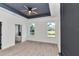 Bright main bedroom boasts a tray ceiling, ceiling fan and two large windows at 7 Hill Prince Dr, Ocala, FL 34482