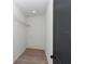 Walk-in closet is equipped with shelving and wood-look tile flooring at 7 Hill Prince Dr, Ocala, FL 34482