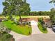 Aerial view showcasing the house's setting, with lush lawns and mature trees at 10672 Sw 75Th Ter, Ocala, FL 34476