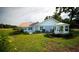 Exterior view of home with a manicured lawn, garden, and a lovely white gazebo at 10672 Sw 75Th Ter, Ocala, FL 34476