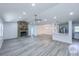 Spacious open-concept living room featuring a stone fireplace and modern flooring at 10672 Sw 75Th Ter, Ocala, FL 34476