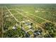 Aerial view of the property surrounded by lush greenery in a serene location at 2310 Laguna Dr, Indian Lake Estates, FL 33855