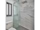 Bathroom showcasing a tiled shower with glass door and modern fixtures at 2310 Laguna Dr, Indian Lake Estates, FL 33855