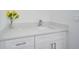 Bathroom vanity featuring a bright countertop, modern faucet, and white cabinets at 2310 Laguna Dr, Indian Lake Estates, FL 33855