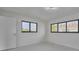 Well-lit bedroom with smooth floors and two modern windows offering exterior views at 2310 Laguna Dr, Indian Lake Estates, FL 33855