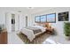 Bright bedroom with a modern aesthetic, featuring a large window and spacious closet at 2310 Laguna Dr, Indian Lake Estates, FL 33855