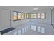 An airy bonus room showcasing sleek tile floors, natural light, and neutral colors at 2310 Laguna Dr, Indian Lake Estates, FL 33855