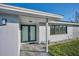 Inviting front entrance with modern double doors and tiled walkway at 2310 Laguna Dr, Indian Lake Estates, FL 33855