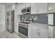 Modern kitchen with stainless steel appliances and white cabinets at 2310 Laguna Dr, Indian Lake Estates, FL 33855