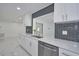 Modern kitchen with stainless steel appliances and gray backsplash at 2310 Laguna Dr, Indian Lake Estates, FL 33855
