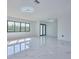 Spacious living room featuring abundant natural light and marble floors at 2310 Laguna Dr, Indian Lake Estates, FL 33855