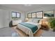 Comfortable main bedroom featuring a large bed, neutral tones, and ample natural light at 2310 Laguna Dr, Indian Lake Estates, FL 33855