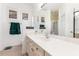 An updated bathroom with a large vanity, framed mirror and tiled floors at 339 Magical Way, Kissimmee, FL 34744