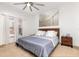Cozy bedroom with a comfortable bed, ceiling fan, and natural light from the window at 339 Magical Way, Kissimmee, FL 34744