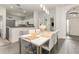 Open floor plan with modern dining area and white table with clear chairs and updated fixtures at 339 Magical Way, Kissimmee, FL 34744