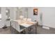 Bright dining room features modern decor, white table, and gray laminate flooring at 339 Magical Way, Kissimmee, FL 34744