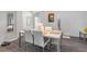 Bright dining area with modern table and chairs, stylish decor, and laminate flooring at 339 Magical Way, Kissimmee, FL 34744