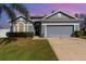 Charming single-story home with a manicured lawn, two-car garage, and freshly painted exterior at 339 Magical Way, Kissimmee, FL 34744