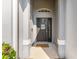 Welcoming front entrance featuring a stylish black door, sidelight, and decorative transom window at 339 Magical Way, Kissimmee, FL 34744