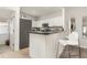 Kitchen with breakfast bar, stainless steel appliances, and adjacent laundry room at 339 Magical Way, Kissimmee, FL 34744