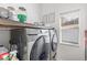 Functional laundry room with washer, dryer, built-in shelf, and a window at 339 Magical Way, Kissimmee, FL 34744