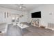 Spacious living room with ample natural light, ceiling fan, and stylish gray laminate flooring at 339 Magical Way, Kissimmee, FL 34744