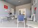 Covered patio features furniture, grill, and white double doors to the outside at 339 Magical Way, Kissimmee, FL 34744