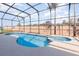 Sparkling screened-in pool and spa surrounded by concrete patio at 339 Magical Way, Kissimmee, FL 34744
