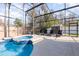 Screened-in pool with spa and lounge chairs and a small grey storage shed at 339 Magical Way, Kissimmee, FL 34744
