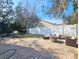 Backyard features a paver patio with a built-in firepit and outdoor seating at 5685 Lake Victoria Dr, Lakeland, FL 33813
