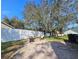 Private backyard features a paver patio with a fire pit and lush landscaping at 5685 Lake Victoria Dr, Lakeland, FL 33813