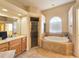 Beautiful bathroom with a large tub, walk-in shower, and double sink vanity at 5685 Lake Victoria Dr, Lakeland, FL 33813