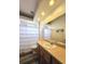 Bathroom featuring a shower, a light vanity, and updated lighting at 5685 Lake Victoria Dr, Lakeland, FL 33813