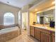 Bathroom featuring a soaking tub, natural light, and a vanity with plenty of storage at 5685 Lake Victoria Dr, Lakeland, FL 33813