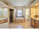 Spacious bathroom featuring a soaking tub, a glass-enclosed shower, and double vanities at 5685 Lake Victoria Dr, Lakeland, FL 33813
