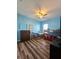Bright blue bedroom with modern furniture, including bunk beds, and a large window at 5685 Lake Victoria Dr, Lakeland, FL 33813