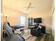 Bedroom featuring wood-look floors, chair, bed, shelves, and a ceiling fan at 5685 Lake Victoria Dr, Lakeland, FL 33813