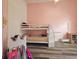 bedroom with a bunk bed, wood-look flooring, and pink walls at 5685 Lake Victoria Dr, Lakeland, FL 33813