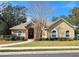 Charming single-story home featuring a stone-accented entrance, arched windows and lush landscaping at 5685 Lake Victoria Dr, Lakeland, FL 33813