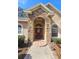 Inviting front entrance with stone facade, arched entryway, and a vibrant red door at 5685 Lake Victoria Dr, Lakeland, FL 33813